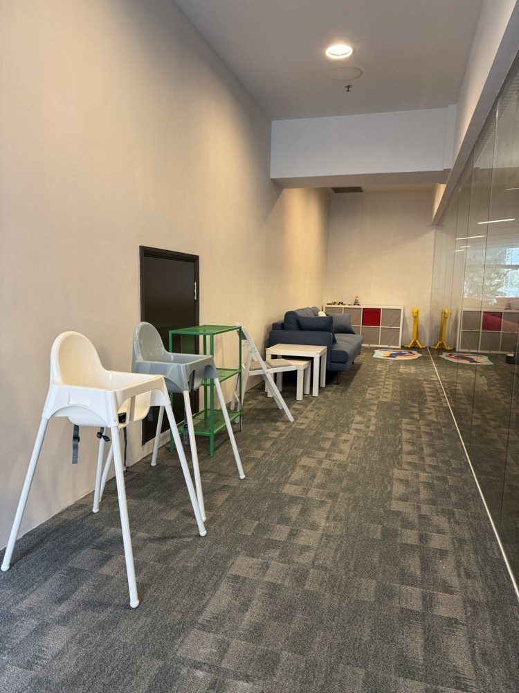 The Nursery with seating, highchairs and a window overlooking the Level 1 sanctuary