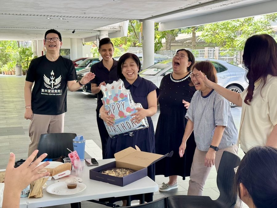 RCC friends laughing together at a birthday celebration